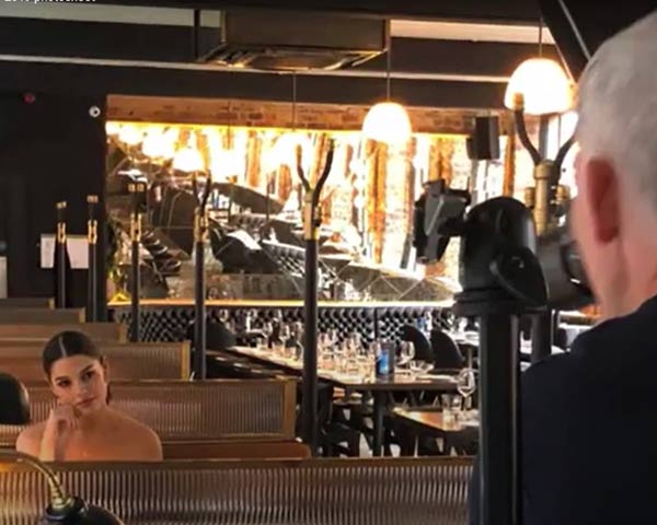 a photographer is taking a photo of a model in the nice room