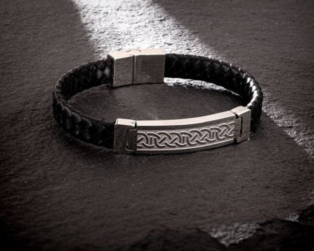 styled image of mens celtic bracelet on dark grey background