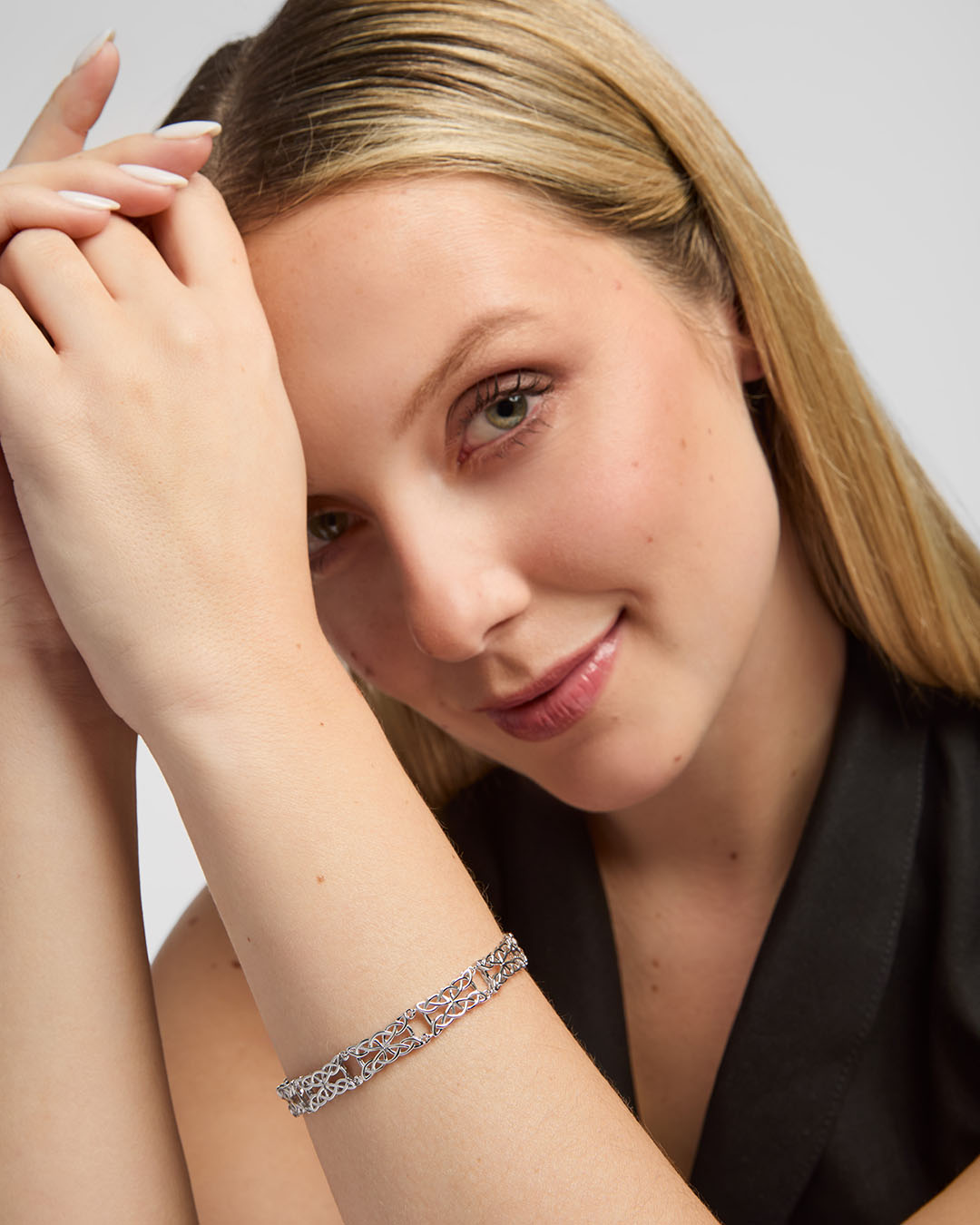 lifestyle image of Solvar silver celtic knotwork link bracelets on a female model