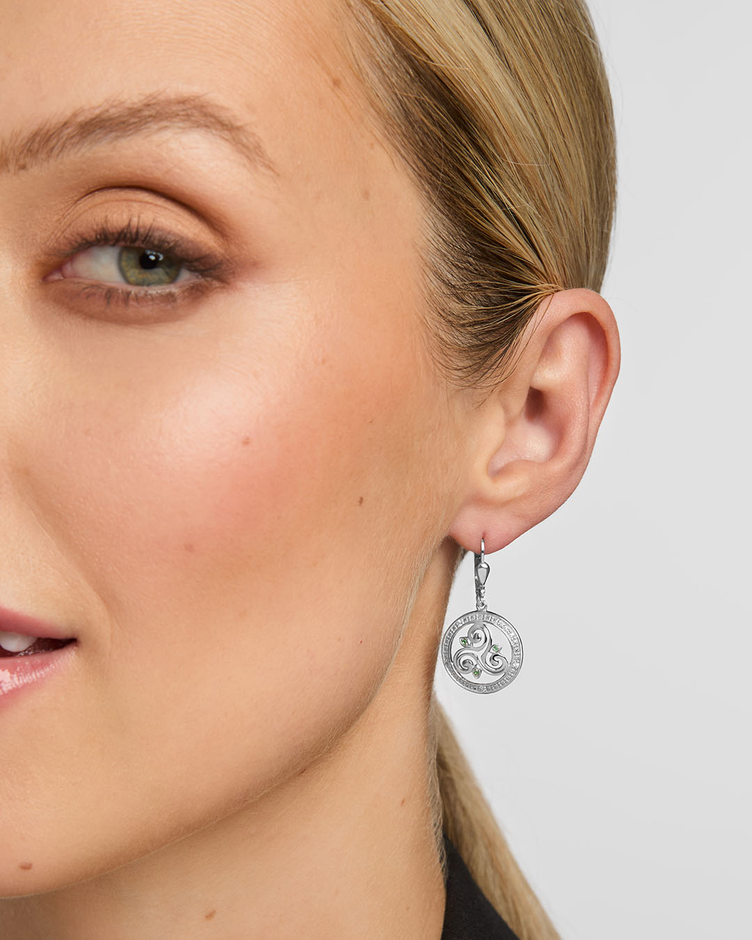 close-up image of celtic spiral drop earrings on a model