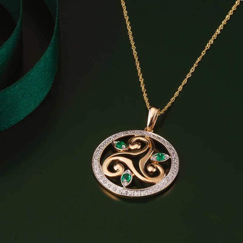 lifestyle image of gold emerald celtic spiral necklace