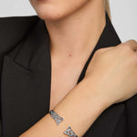 a female model wearing celtic torc bangle in sterling silver