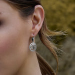 a model wearing Irish tree of life drop earrings 
