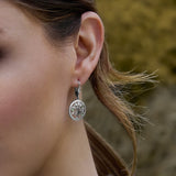 a model wearing Irish tree of life drop earrings 