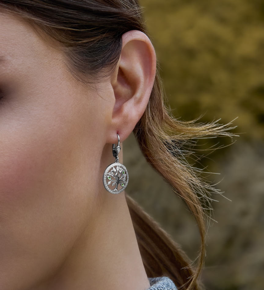 a model wearing Irish tree of life drop earrings 