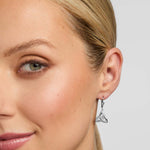 close-up image of a female model wearing Celtic Trinity Knot earrings in silver
