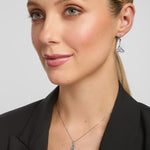 a female model wearing matching celtic trinity knot pendant and earrings set in sterling silver