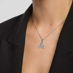 close-up image of celtic trinity knot pendant on a model