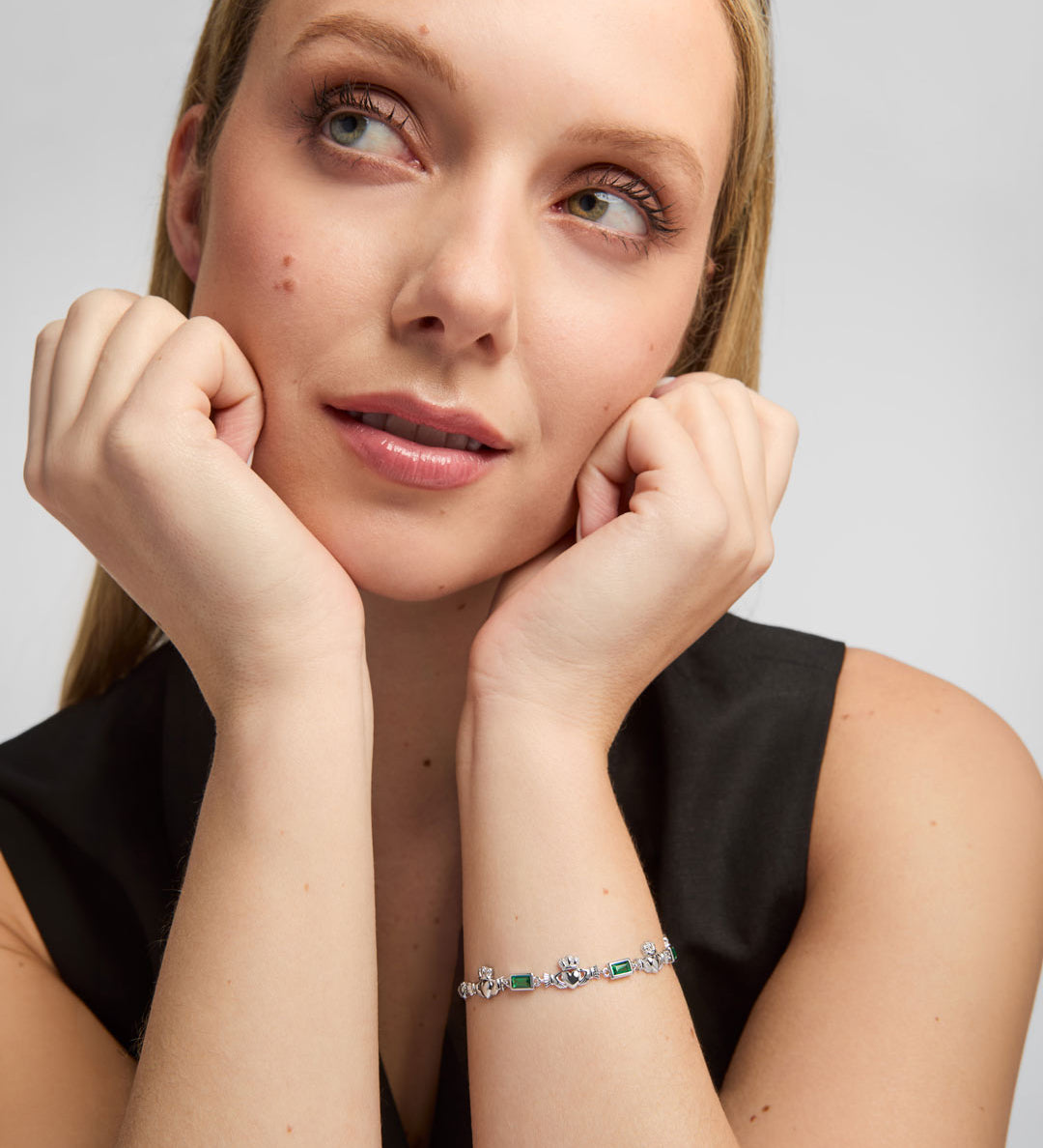 green cz silver claddagh bracelet on a female model