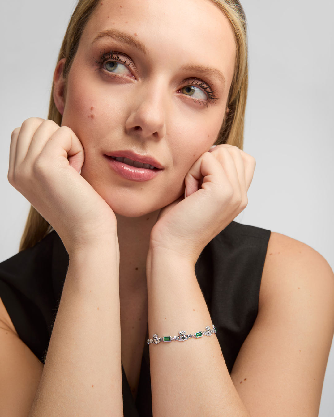 green cz silver claddagh bracelet on a female model