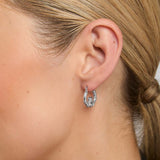 close-up image of claddagh  hoop earrings on a female model