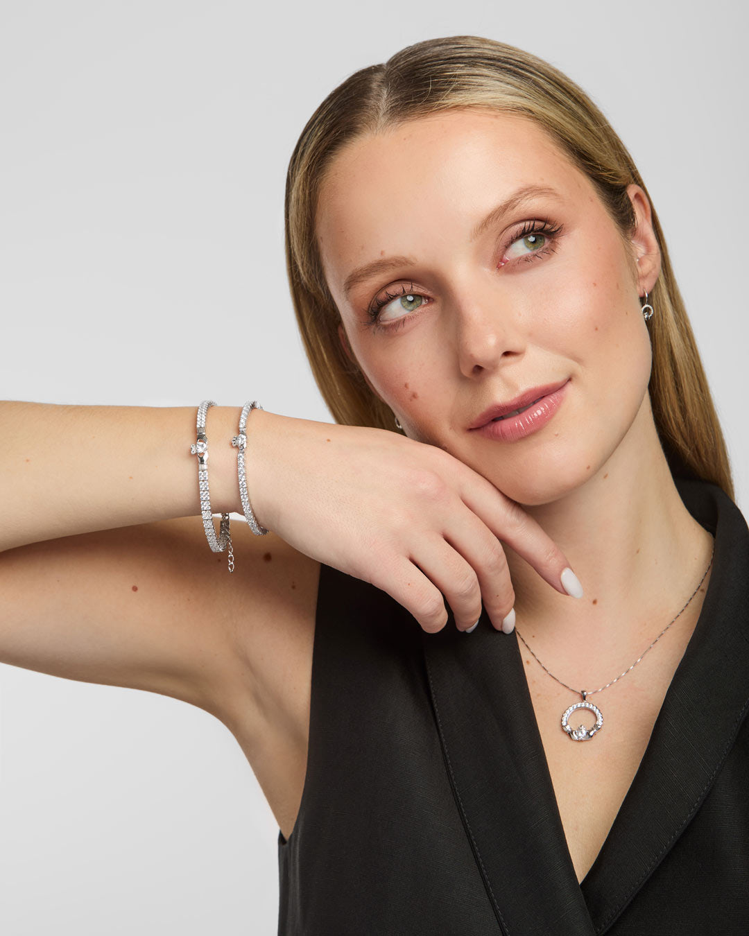  lifestyle shot of Solvar Claddagh tennis bracelet and bangle on a woman's wrist, emphasizing detail and shine