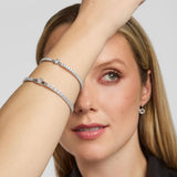 Close-up of a woman’s wrist wearing a Solvar Claddagh tennis bracelet and matching bangle, highlighting intricate details and elegant design