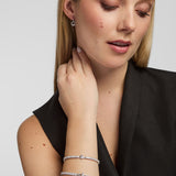 Lifestyle image of Solvar Claddagh tennis bracelet and bangle worn on a woman’s wrist in a relaxed setting