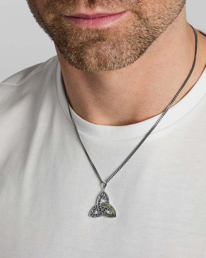 closeup image of men's green marble Celtic Trinity Knot necklace on a model