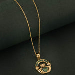 Connemara Marble gold Claddagh necklace on green background