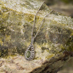 lifestyle image of marble & marcasite celtic necklace on connemara marble background