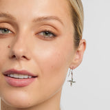 green marble saint brigids cross drop earrings on a model