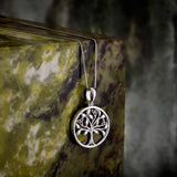 lifestyle image of silver connemara marble tree of life necklace s46669 on green marble stone 1