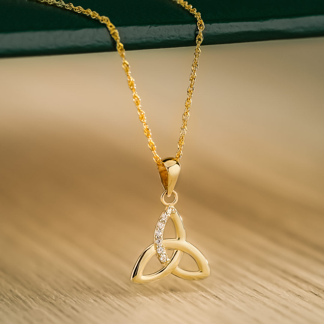 lifestyle image of yellow gold cubic zirconia trinity knot necklace from Solvar