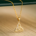 lifestyle image of yellow gold cubic zirconia trinity knot necklace from Solvar