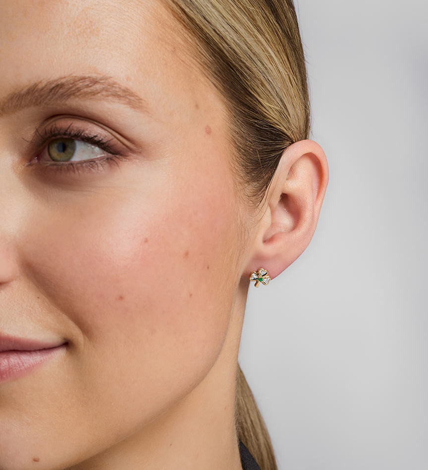 a model wearing diamond & emerald shamrock stud earrings s3975
