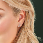 mixed metal Celtic Trinity Knot stud earrings on a model