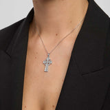 close-up image of double-sided embossed celtic cross pendant on a model