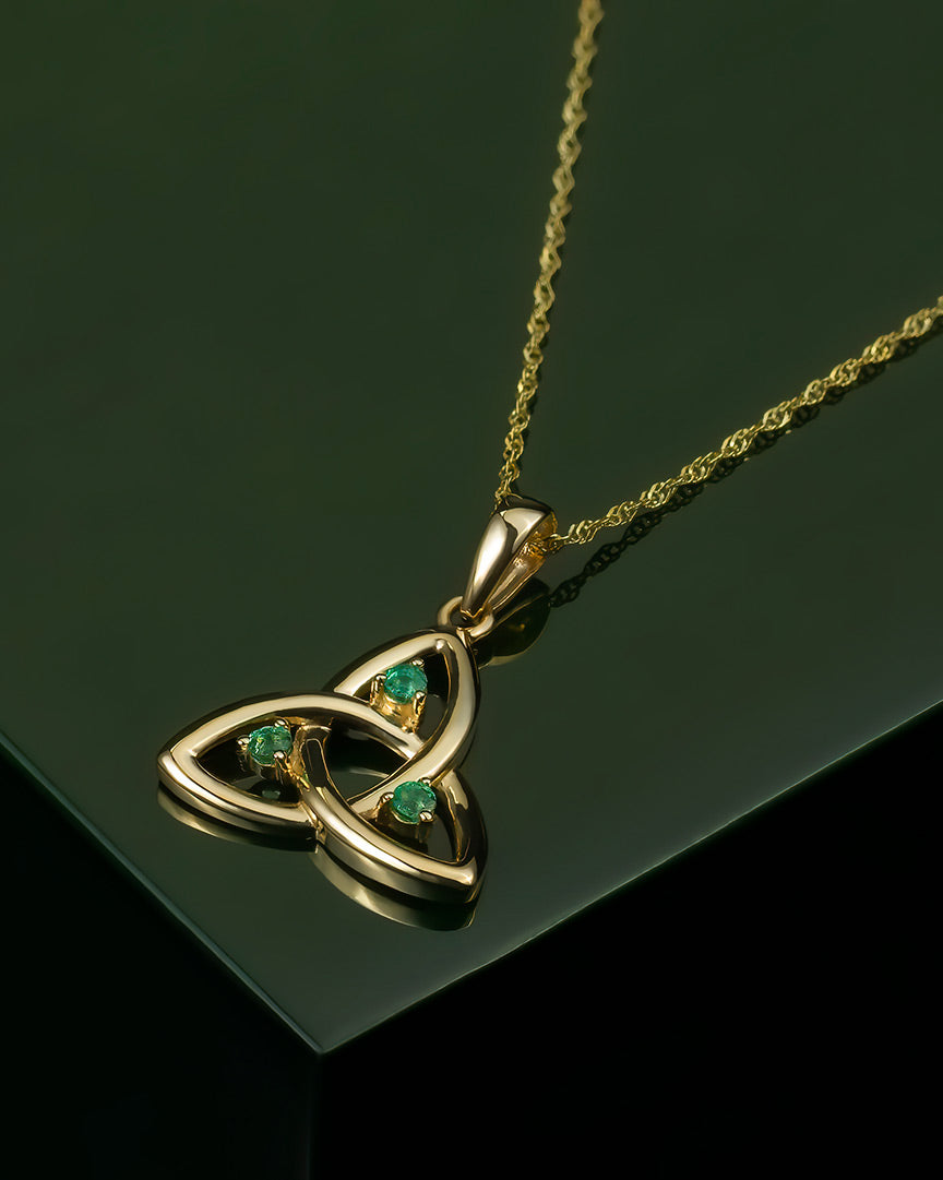 lifestyle image of emerald celtic necklace on green background