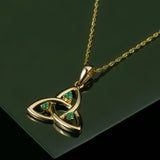 lifestyle image of emerald celtic necklace on green background