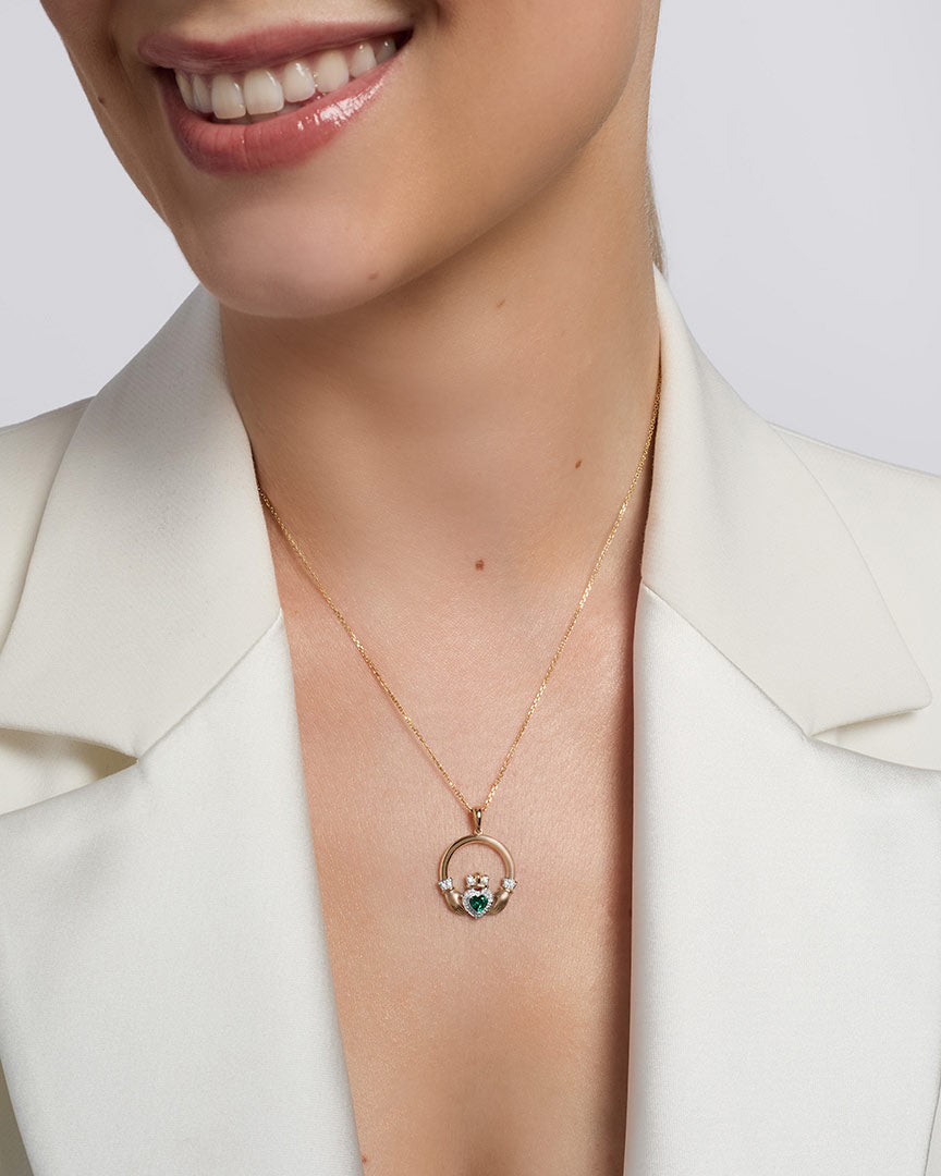 a model wearing 14k gold emerald claddagh pendant s46096