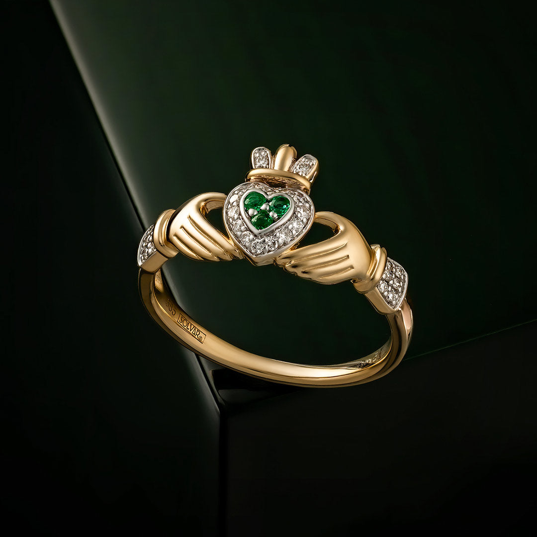 styled image of 14K gold diamond and emerald set claddagh ring s2945 from Solvar