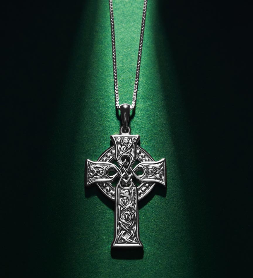 styled image of small four apostles celtic cross pendant s46604 on green background