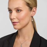 a set of freshwater pearl celtic necklace and earrings presented on a model