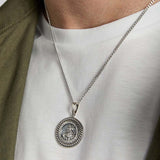 closeup image of silver st Christopher medal pendant on a male model