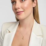 solid 9k gold Irish harp pendant on a female model against neutral background