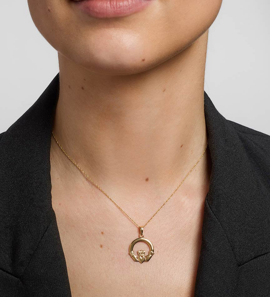 gold heavy claddagh pendant on a model 1
