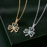 styled image of matching white and yellow gold emerald shamrock pendants