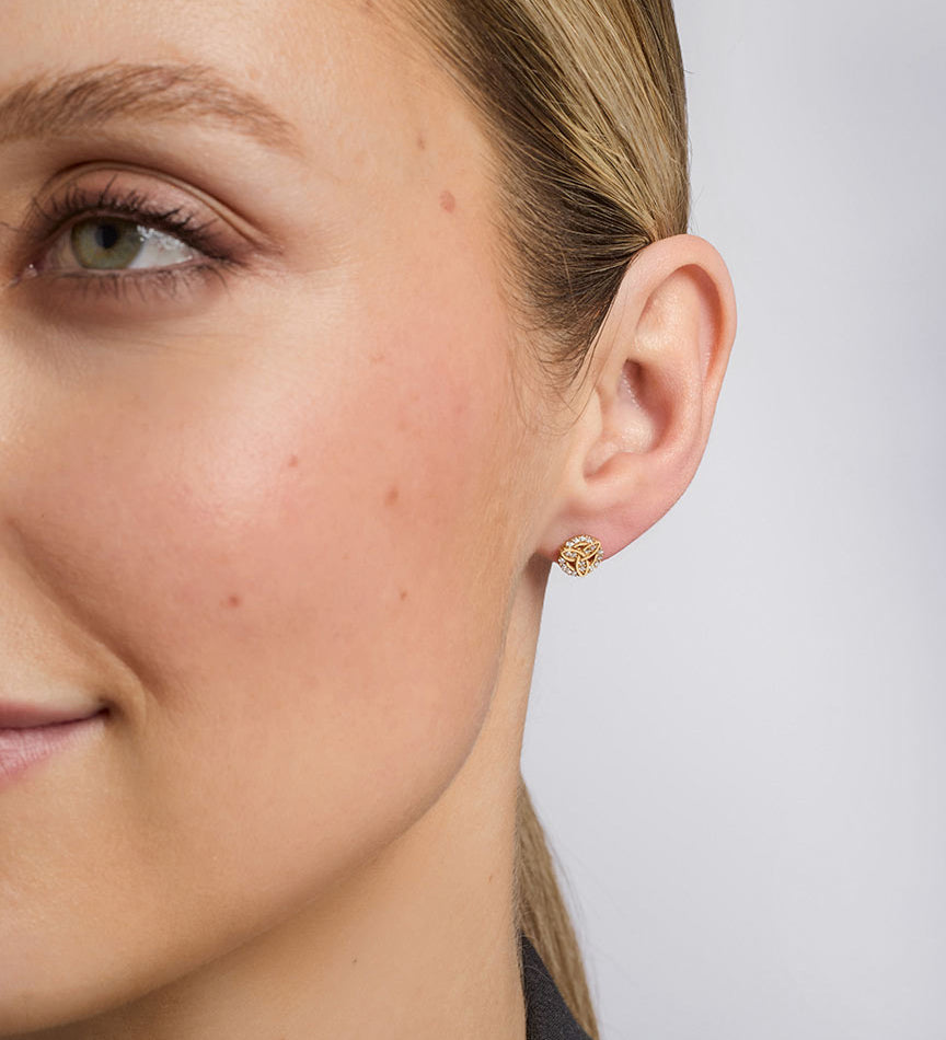a model wearing Solvar cz set trinity knot stud earrings s34202