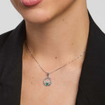 Claddagh necklace with a green stone  centre on a female model