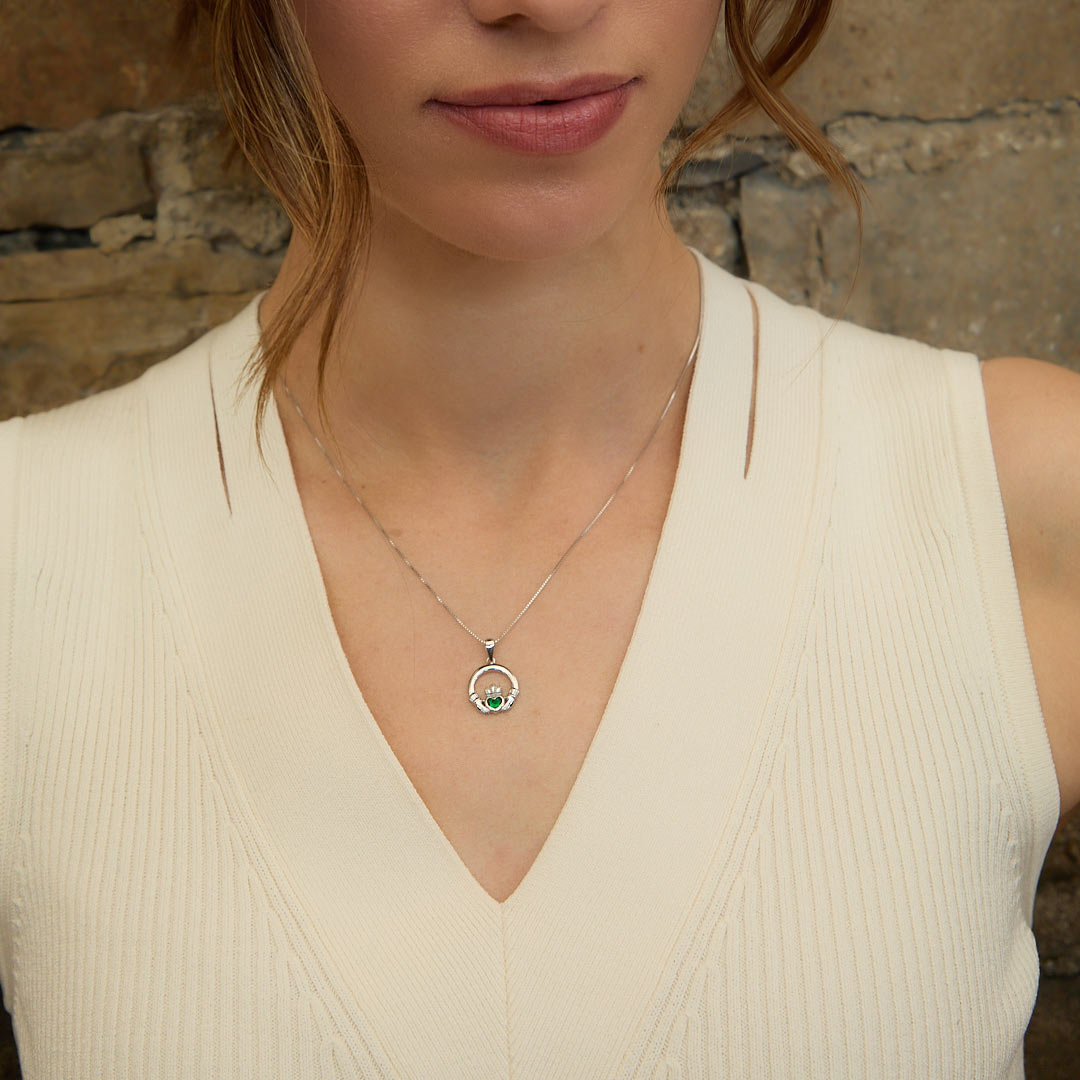 lifestyle image of green crystal Claddagh pendant on a female mode