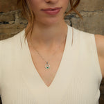 lifestyle image of green crystal Claddagh pendant on a female mode