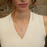 lifestyle image of green crystal Claddagh pendant on a female mode