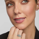 close-up image of green cz claddagh ring on a female model