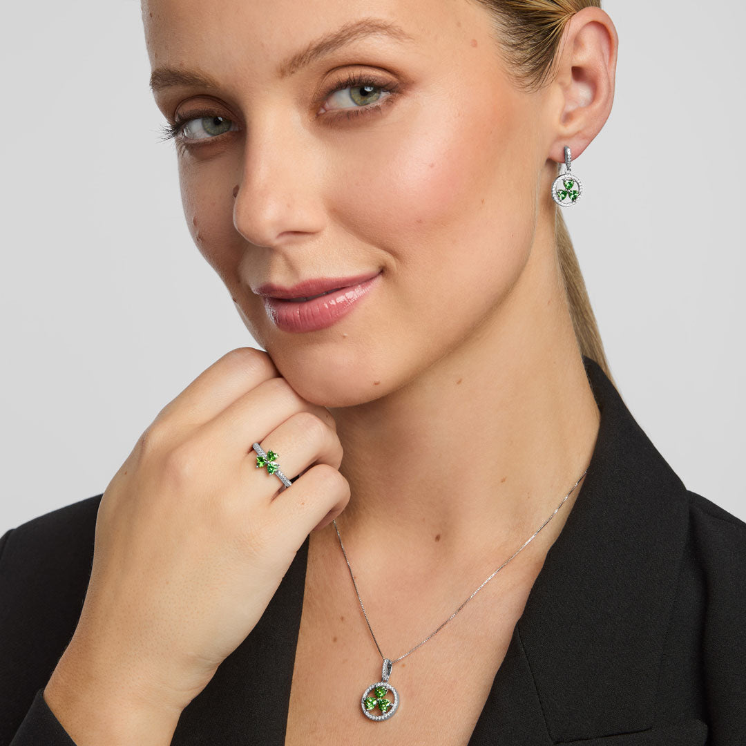 a female model wearing matching green CZ Shamrock ring, earrings, and necklace