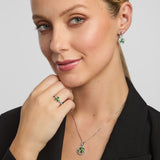 a female model wearing matching green CZ Shamrock ring, earrings, and necklace