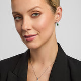matching green CZ trinity knot necklace and earrings on a female model