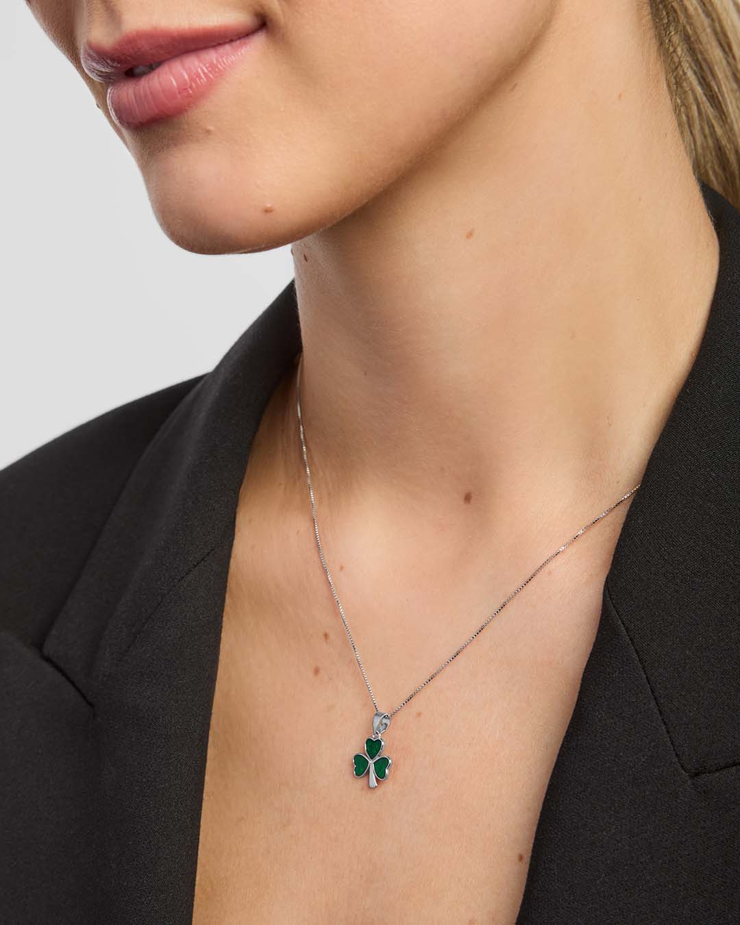 close-up of a female model wearing green Shamrock pendant from Solvar