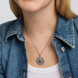 close-up image of oval connemara marble large celtic knot pendant on a female model  