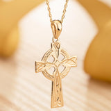 lifestyle image of hand engraved gold celtic cross necklace 1